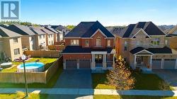 View of front of property with a front lawn and a garage - 