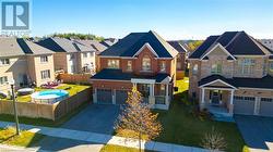 View of front of property featuring a garage and a front yard - 