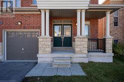 Entrance to property with a garage and covered porch - 