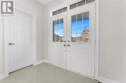 Foyer entrance with light tile patterned flooring - 