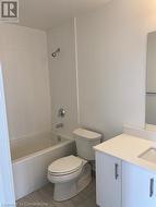 Full bathroom featuring toilet, vanity, and tiled shower / bath - 