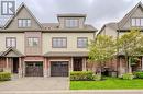 View of front of property featuring a garage. - 146 Downey Road Unit# 22B, Guelph, ON  - Outdoor With Facade 