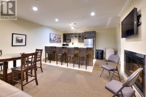 310 - 539 Belmont Avenue W, Kitchener, ON - Indoor Photo Showing Dining Room With Fireplace