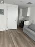 Unfurnished living room featuring electric panel, hardwood / wood-style flooring, and sink - 560 North Service Road Unit# 211, Grimsby, ON  - Indoor 