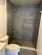 Bathroom with walk in shower, tile patterned flooring, vanity, and toilet - 