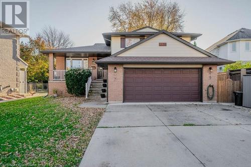 View of front of property with a garage, a front yard, and a porch - 2378 Headon Road, Burlington, ON - Outdoor