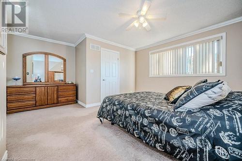 Bedroom with ornamental molding, carpet, a textured ceiling, and ceiling fan - 2378 Headon Road, Burlington, ON - Indoor Photo Showing Bedroom