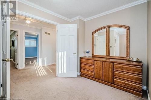 Carpeted bedroom featuring ornamental molding and a textured ceiling - 2378 Headon Road, Burlington, ON - Indoor Photo Showing Other Room