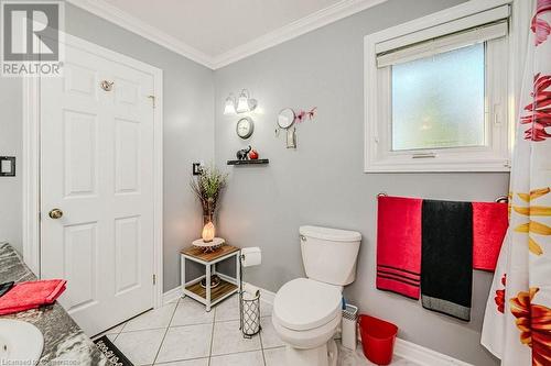 Bathroom with toilet, vanity, tile patterned flooring, and crown molding - 2378 Headon Road, Burlington, ON - Indoor Photo Showing Bathroom