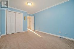 3rd bedroom featuring ornamental molding, carpet, and a textured ceiling - 