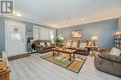 Spacious Living room featuring light vinyl floors, a textured ceiling, and crown molding - 