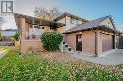 View of front of property featuring a garage and covered porch - 