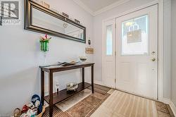 Tiled foyer with ornamental molding - 