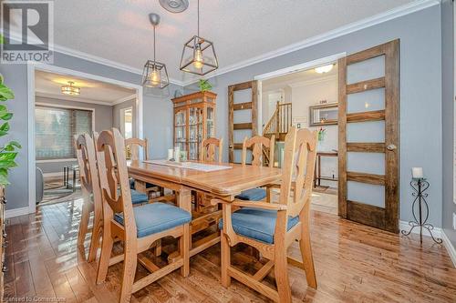 Dining area featuring ornamental molding, light hardwood / wood-style floors, and a textured ceiling - 2378 Headon Road, Burlington, ON - Indoor Photo Showing Dining Room