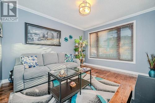 Living room with hardwood / wood-style floors, a textured ceiling, and crown molding - 2378 Headon Road, Burlington, ON - Indoor Photo Showing Living Room