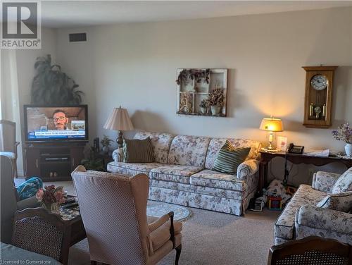 View of carpeted living room - 56 Kerman Avenue Unit# 312, Grimsby, ON - Indoor Photo Showing Living Room