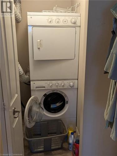 Laundry area featuring stacked washer / dryer - 56 Kerman Avenue Unit# 312, Grimsby, ON - Indoor Photo Showing Laundry Room