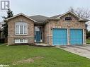 View of front of house featuring a garage and a front lawn - 316 Main Street W, Dundalk, ON  - Outdoor 