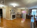 Living room with hardwood / wood-style floors, ornamental molding, and a textured ceiling - 316 Main Street W, Dundalk, ON  - Indoor Photo Showing Other Room With Fireplace 