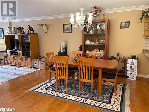 Dining space featuring an inviting chandelier, hardwood / wood-style flooring, and crown molding - 316 Main Street W, Dundalk, ON - Indoor Photo Showing Dining Room