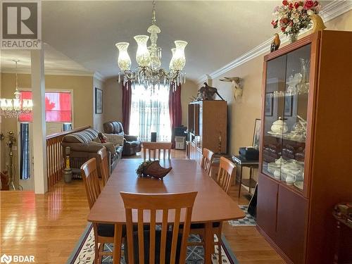 Dining room featuring an inviting chandelier, wood-type flooring, and ornamental molding - 316 Main Street W, Dundalk, ON - Indoor Photo Showing Dining Room