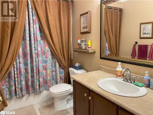 Full bathroom with toilet, vanity, tile patterned floors, and shower / bathtub combination with curtain - 316 Main Street W, Dundalk, ON - Indoor Photo Showing Bathroom