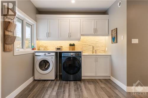 massive laundry and mud room right off kitchen; oodles of storage! - 875 Deertail Lane, Ottawa, ON - Indoor Photo Showing Laundry Room