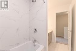 Bathroom with vanity and tiled shower / bath - 