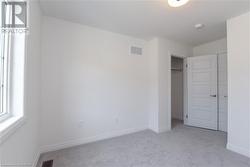 Unfurnished bedroom featuring a closet and light carpet - 