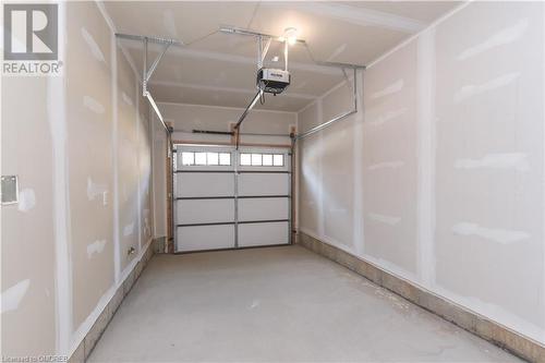 Garage featuring a garage door opener - 620 Colborne Street W Unit# 42, Brantford, ON - Indoor Photo Showing Garage