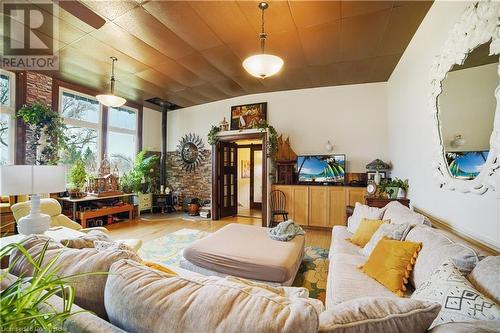 Living room featuring a wood stove and light hardwood / wood-style flooring - 687 Highway 6 Highway, Caledonia, ON - Indoor