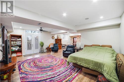 Bedroom featuring french doors and light hardwood / wood-style floors - 687 Highway 6 Highway, Caledonia, ON - Indoor Photo Showing Bedroom