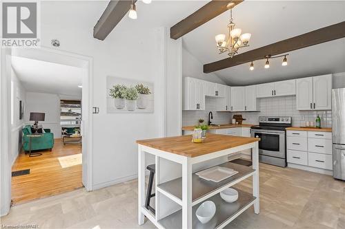 Kitchen featuring stainless steel appliances, white cabinets, hanging light fixtures, backsplash, and wood counters - 233 Nile Street, Stratford, ON - Indoor