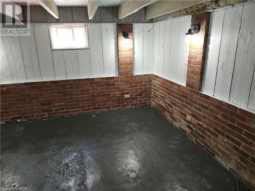 Basement featuring wooden walls and brick wall - 233 Nile Street, Stratford, ON - Indoor