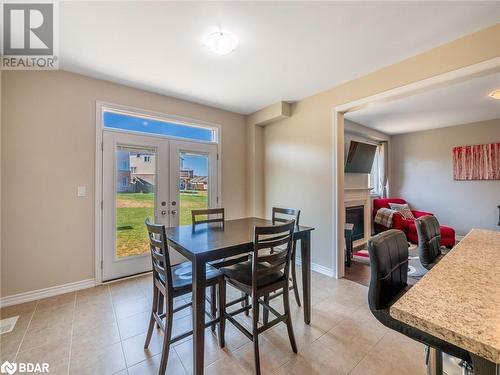 Tiled dining space featuring french doors - 3046 Stone Ridge Boulevard, Orillia, ON - Indoor Photo Showing Dining Room