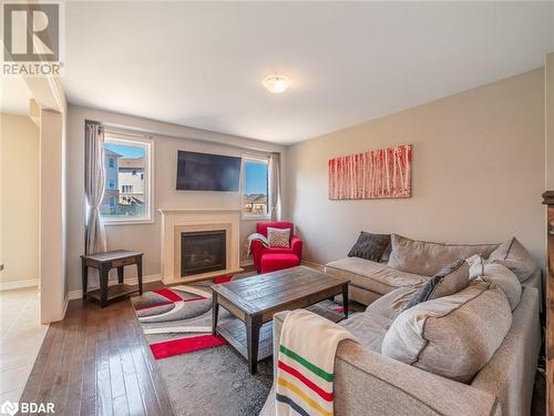 Living room with hardwood / wood-style floors - 3046 Stone Ridge Boulevard, Orillia, ON - Indoor Photo Showing Living Room With Fireplace