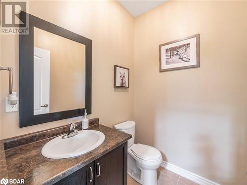 Bathroom with toilet, vanity, and tile patterned floors - 3046 Stone Ridge Boulevard, Orillia, ON - Indoor Photo Showing Bathroom