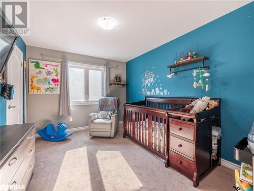 Carpeted bedroom featuring a crib - 3046 Stone Ridge Boulevard, Orillia, ON - Indoor Photo Showing Bedroom