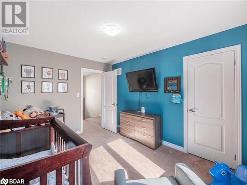 Carpeted bedroom featuring a crib - 3046 Stone Ridge Boulevard, Orillia, ON - Indoor Photo Showing Other Room