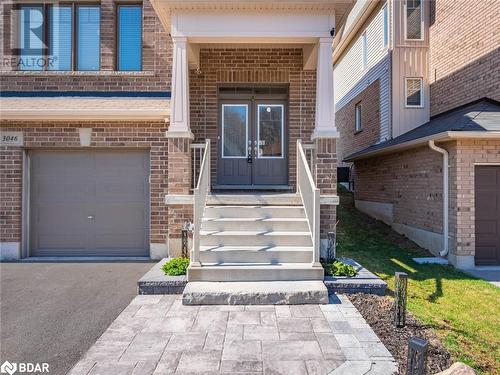 Property entrance with a garage - 3046 Stone Ridge Boulevard, Orillia, ON - Outdoor With Facade