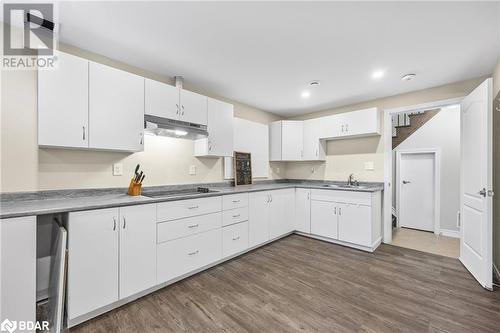 Kitchen featuring white cabinetry, sink, black electric stovetop, and dark hardwood / wood-style flooring - 3046 Stone Ridge Boulevard, Orillia, ON - Indoor Photo Showing Kitchen