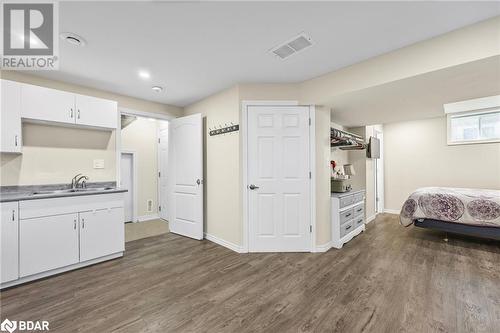 Kitchen with white cabinets, sink, and dark hardwood / wood-style flooring - 3046 Stone Ridge Boulevard, Orillia, ON - Indoor