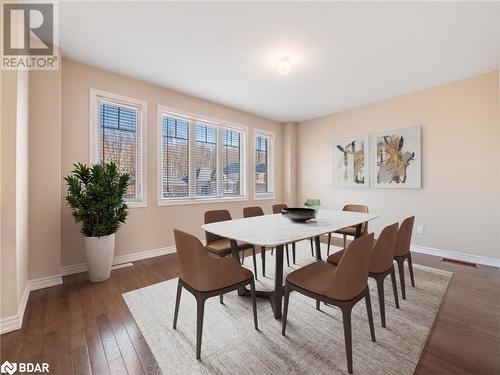 Dining area with dark hardwood / wood-style floors and plenty of natural light - 3046 Stone Ridge Boulevard, Orillia, ON - Indoor Photo Showing Dining Room