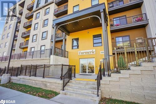 View of building exterior - 8 Culinary Lane Unit# 402, Barrie, ON - Outdoor With Balcony