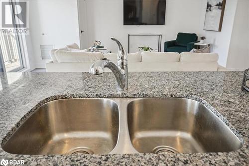 Interior details with stone countertops and sink - 8 Culinary Lane Unit# 402, Barrie, ON - Indoor Photo Showing Kitchen With Double Sink