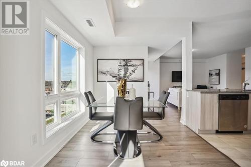 Dining area featuring a wealth of natural light, light hardwood / wood-style floors, and sink - 8 Culinary Lane Unit# 402, Barrie, ON - Indoor