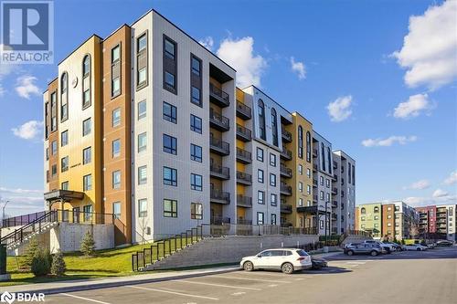 View of building exterior - 8 Culinary Lane Unit# 402, Barrie, ON - Outdoor With Balcony With Facade