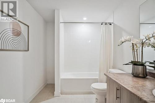 Full bathroom with shower / bath combo, tile patterned flooring, vanity, and toilet - 8 Culinary Lane Unit# 402, Barrie, ON - Indoor Photo Showing Bathroom