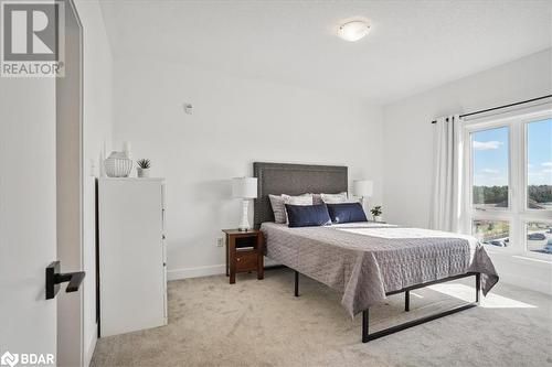 View of carpeted bedroom - 8 Culinary Lane Unit# 402, Barrie, ON - Indoor Photo Showing Bedroom