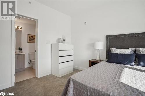 Bedroom featuring connected bathroom and carpet - 8 Culinary Lane Unit# 402, Barrie, ON - Indoor Photo Showing Bedroom